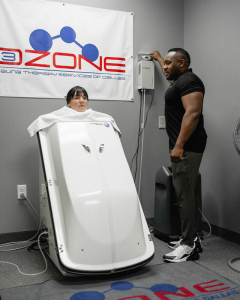 Trainer Assisting Client With Recovery Therapy Session at Hidden Gym