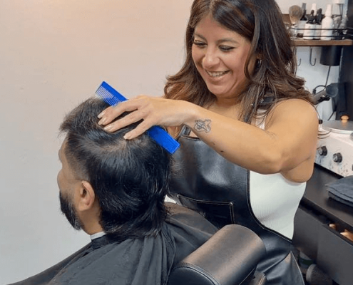 Stylist Combing Client's Hair at Change It Studio in Hidden Gym Stylist Combing Client's Hair at Change It Studio in Hidden Gym