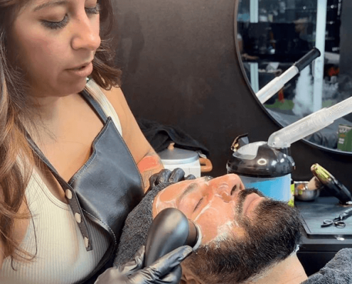 Barber Giving Client Facial Treatment at a Salon inside Hidden Gym Barber Giving Client Facial Treatment at a Salon inside Hidden Gym